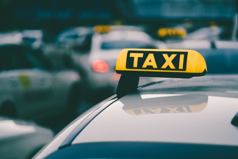 selective-focus-shot-yellow-taxi-sign-traffic-jam