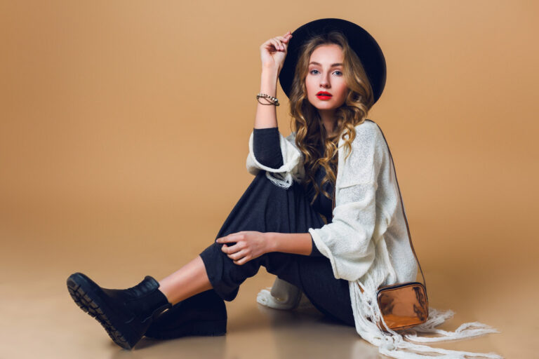 high-fashion-portrait-young-elegant-blonde-woman-black-wool-hat-wearing-oversize-white-fringe-poncho-with-long-grey-dress